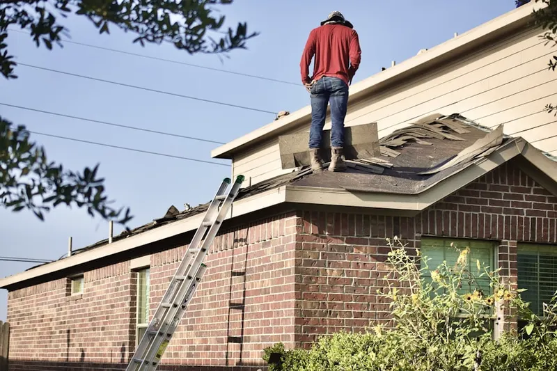 Professional roofer working on a residential roof in Frenchtown Woods